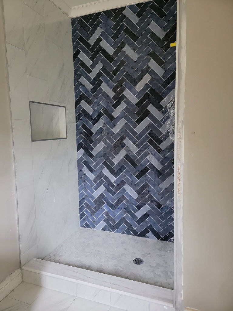Shower tile herringbone installation